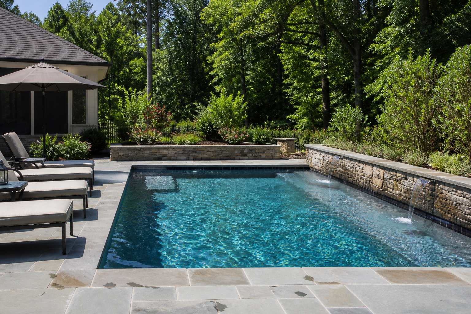 Plunge pool and stone deck on a bright summer afternoon — mood imagery, not a client project